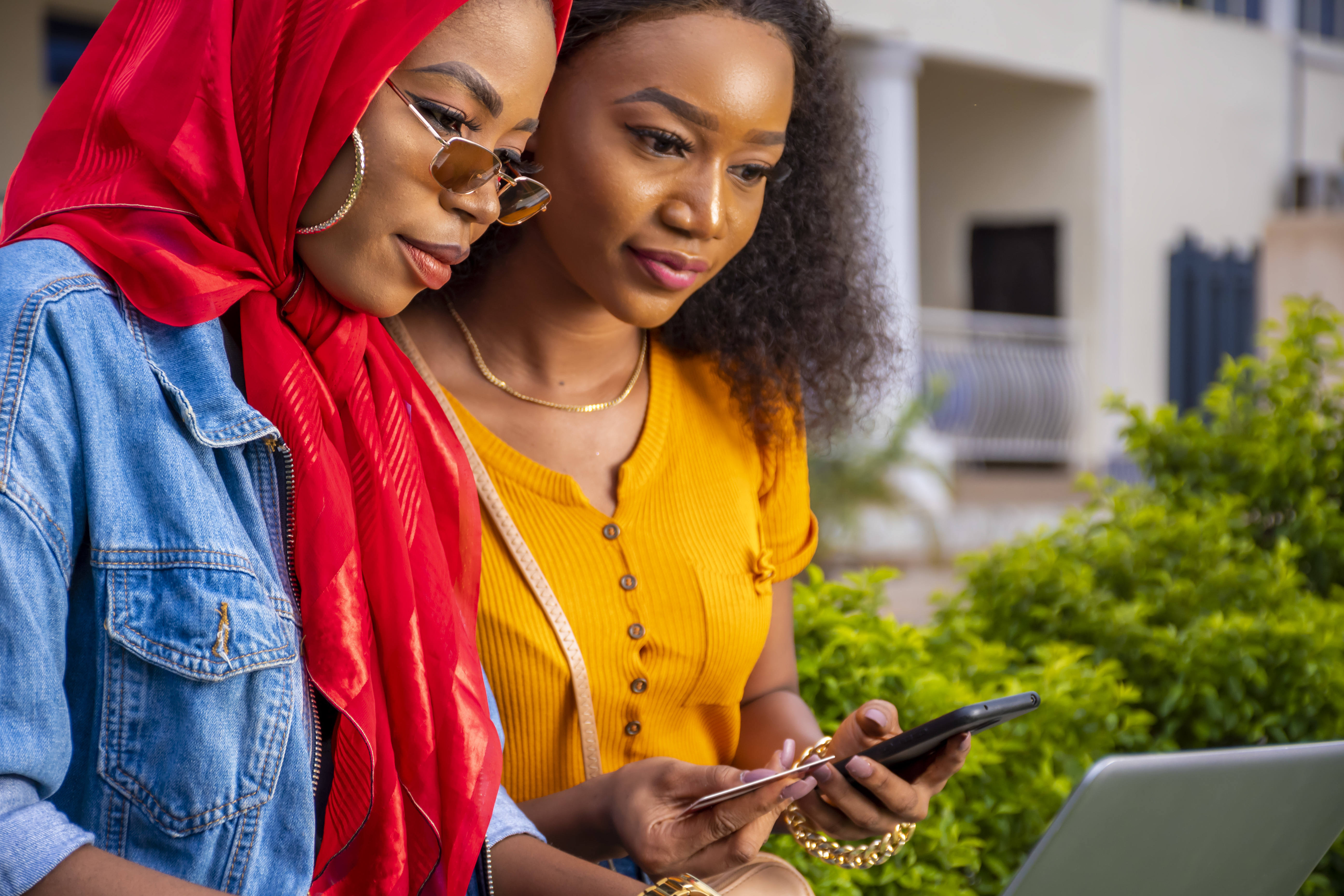 african-females-shopping-online-while-sitting-park.jpg
