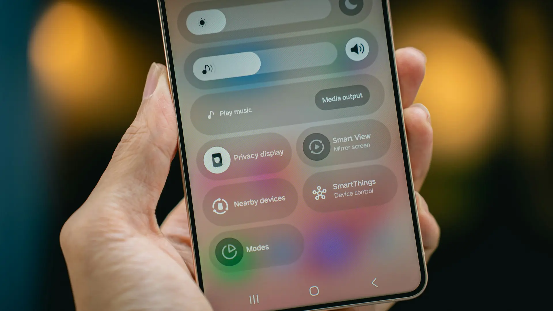 A person holding a smartphone while reviewing privacy controls