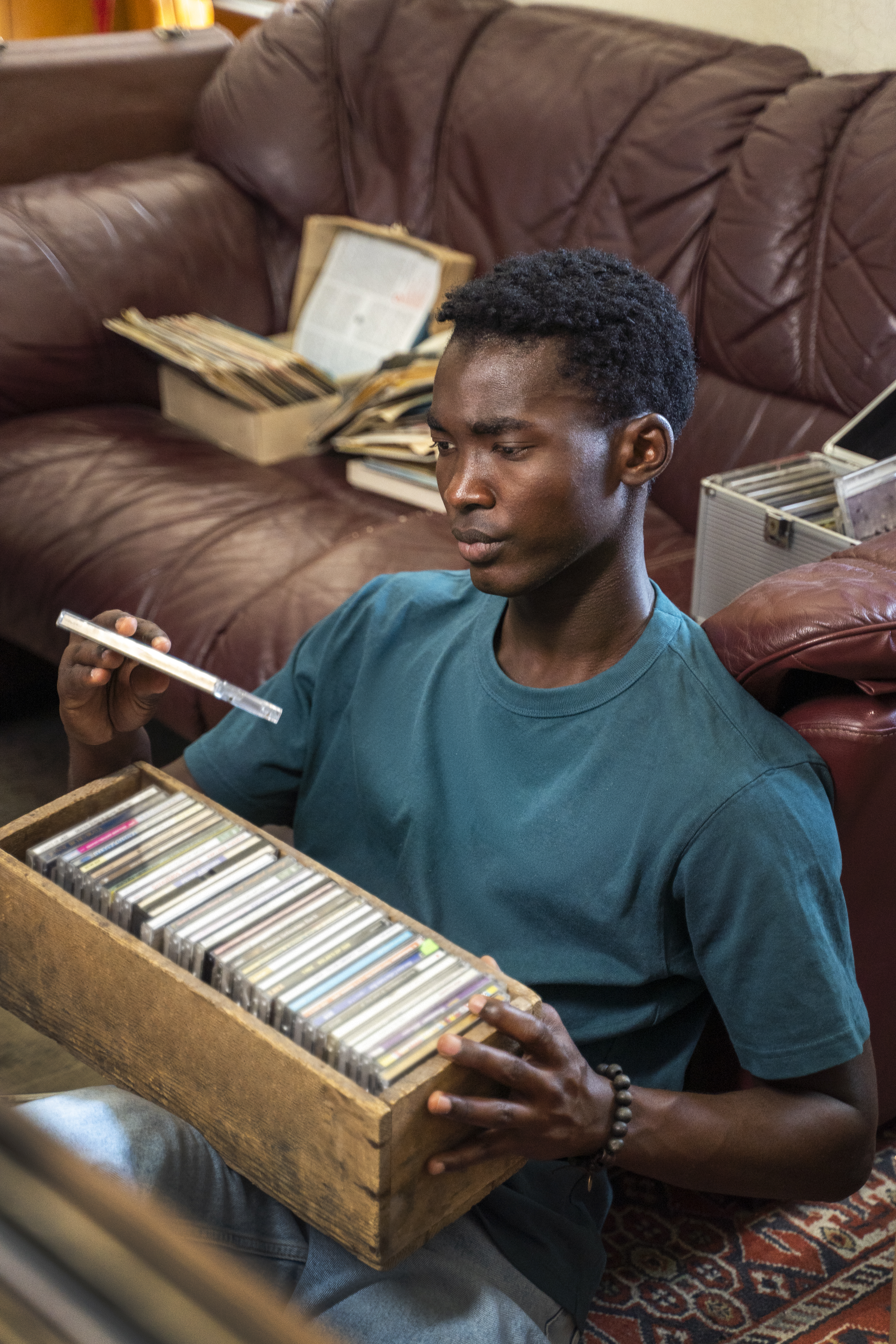man holding vinyl  records side view