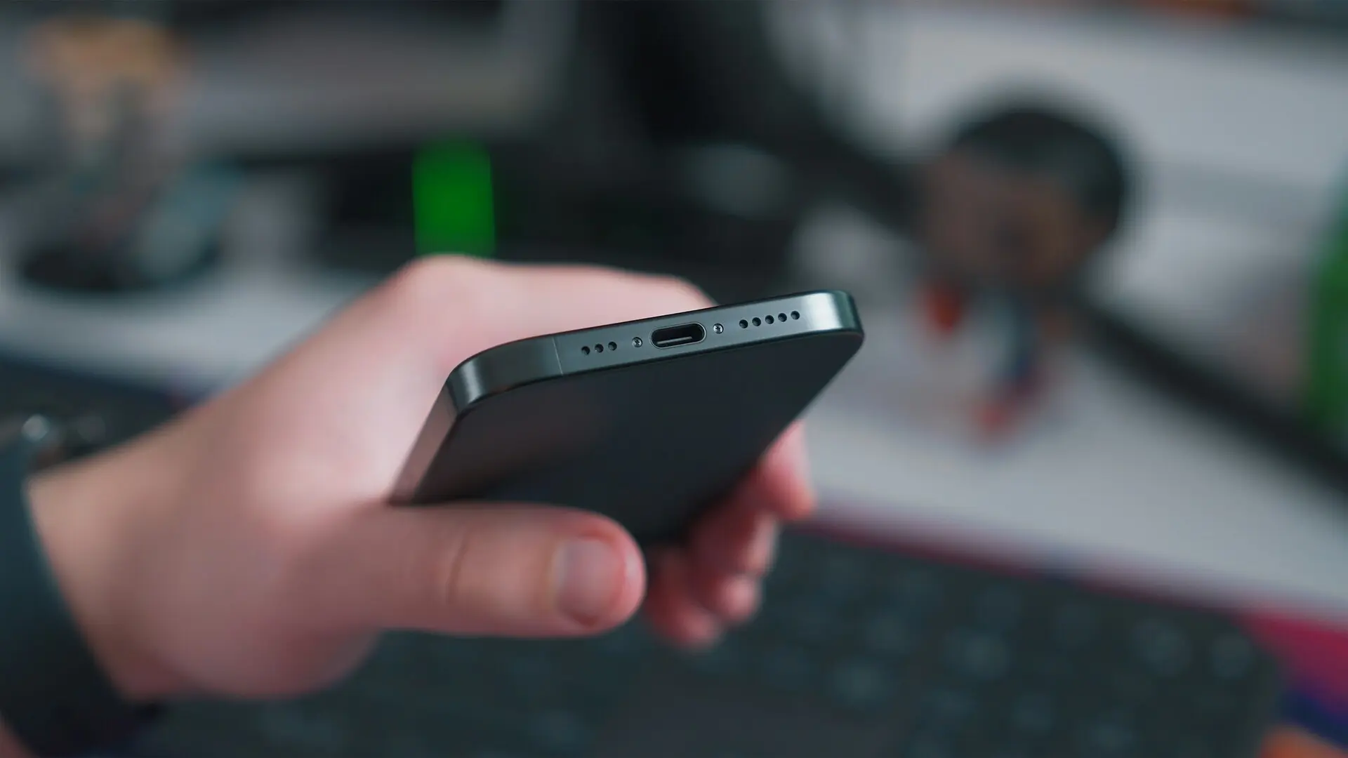A person holding a smartphone while reviewing important phone settings