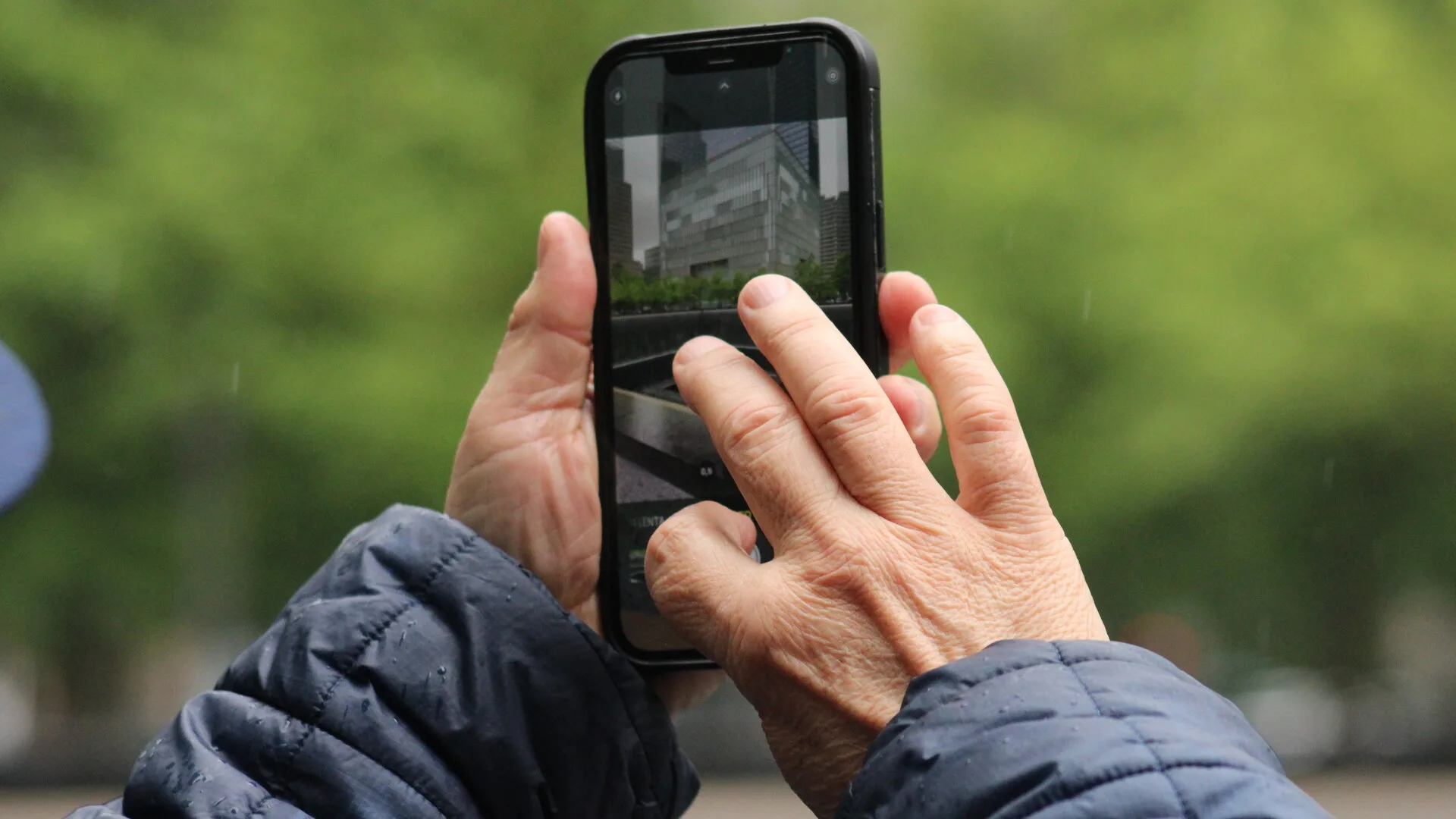 A person using a phone camera while managing digital photos
